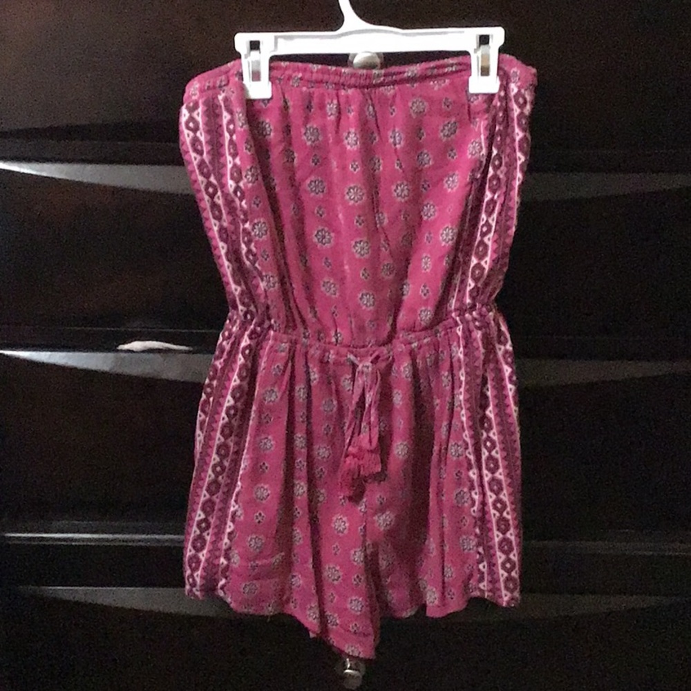 A pink dress with a no sleeve jean jacket